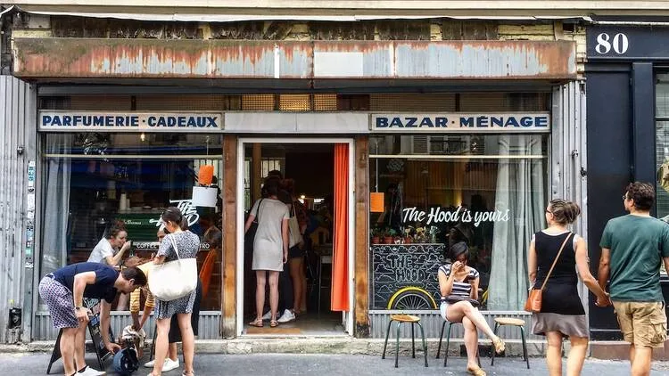 parisian storefront with "bazar menage" and customers gathered outside on street., the hood, paris