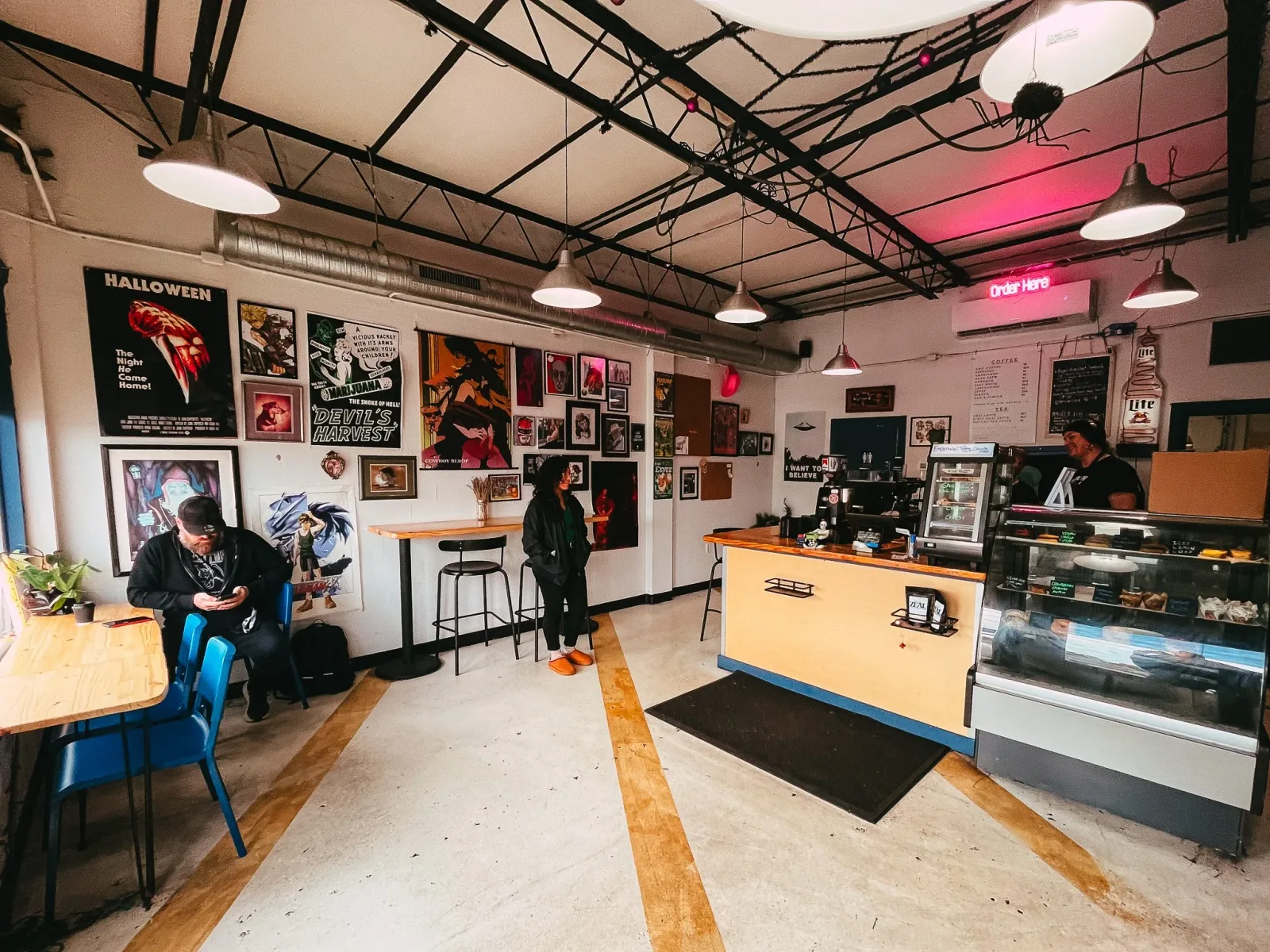 industrial café interior with horror movie posters and neon signage., the lab coffee - west tampa, tampa