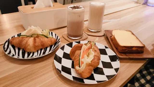 bakery items and pastries displayed on patterned plates with beverages., the light x coffee art n design灯泡咖啡館 手沖｜滬掛｜軽食｜甜点｜芸術｜