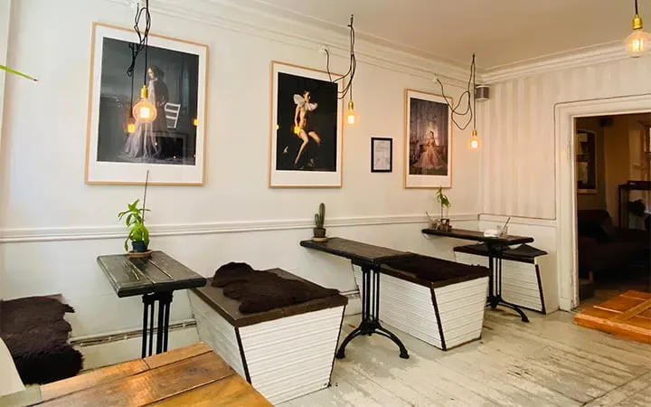 modern minimalist interior with benches, pendant lights, and framed artwork on walls., the little yellow coffee bar, copenhag