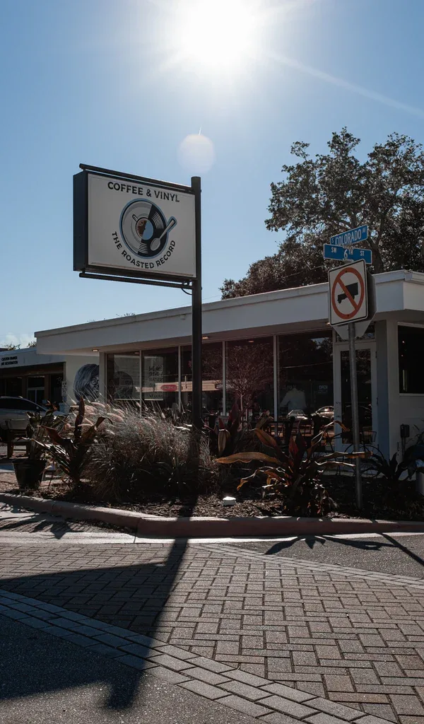 coffee shop storefront with vinyl record logo sign on sunny day., the roasted record coffee and vinyl, port saint lucie