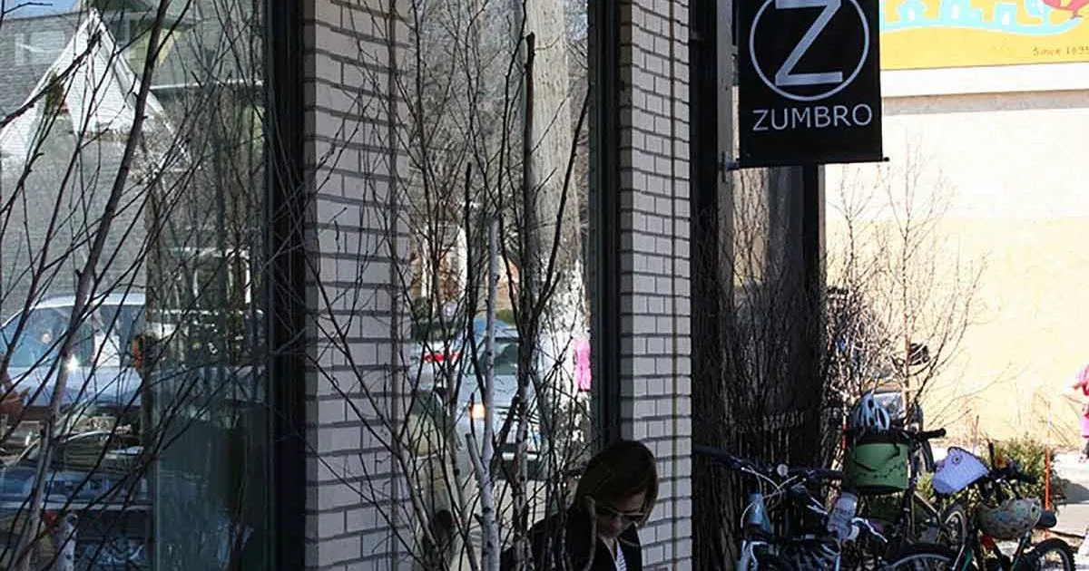 urban street storefront with zumbro sign, bare vines, bicycles parked outside., the zumbro cafe, minnesota