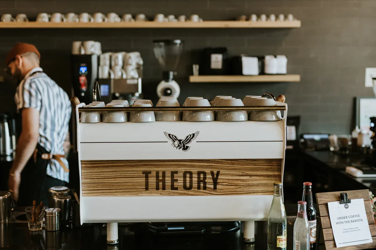 theory espresso machine with cups in modern minimalist coffee shop interior., theory coffee roasters, redding
