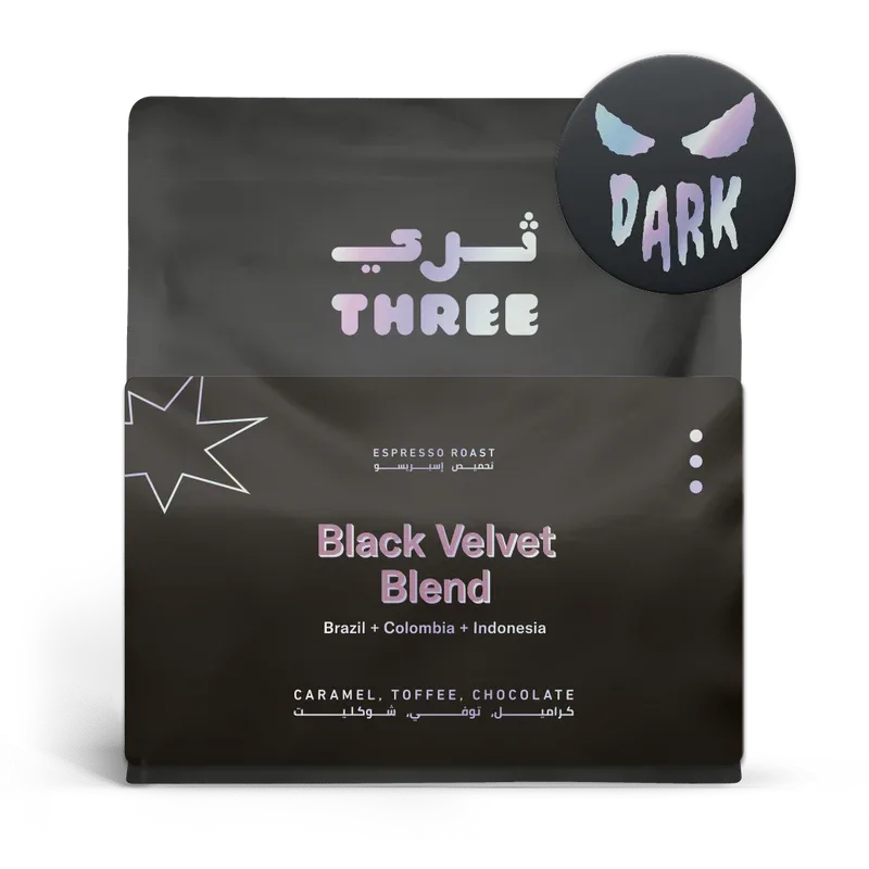 dark roasted coffee bag with arabic and english text, featuring purple and blue branding., three coffee, dubai