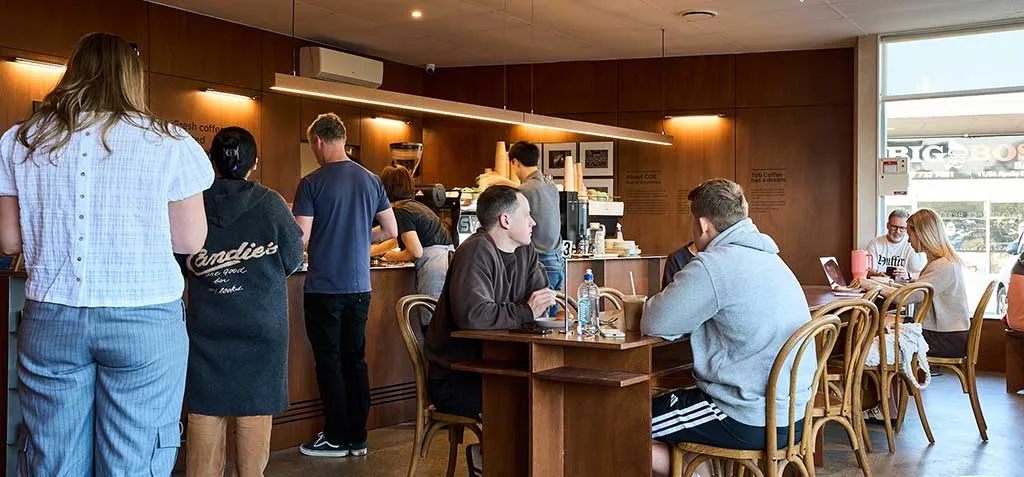 cozy coffee shop interior with customers ordering and seated at wooden tables., tob coffee, auckland