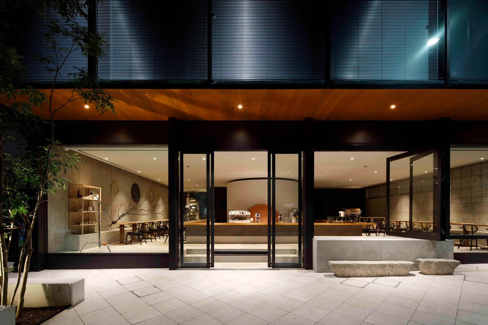 modern café exterior with illuminated interior, wooden counters, and minimalist design at night., tokyo coffee lab., tokyo