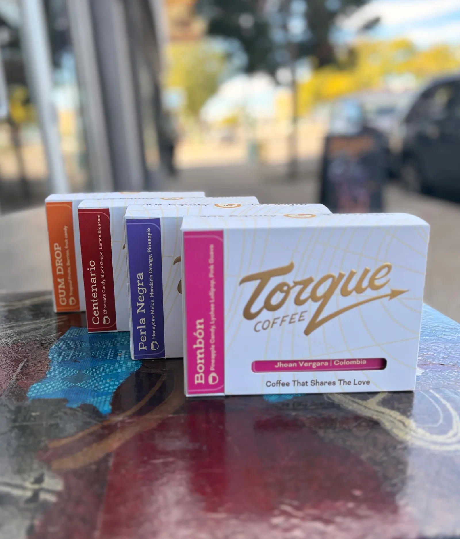 torque coffee boxes displayed outdoors with colorful variant packages lined up., torque coffees, vancouver
