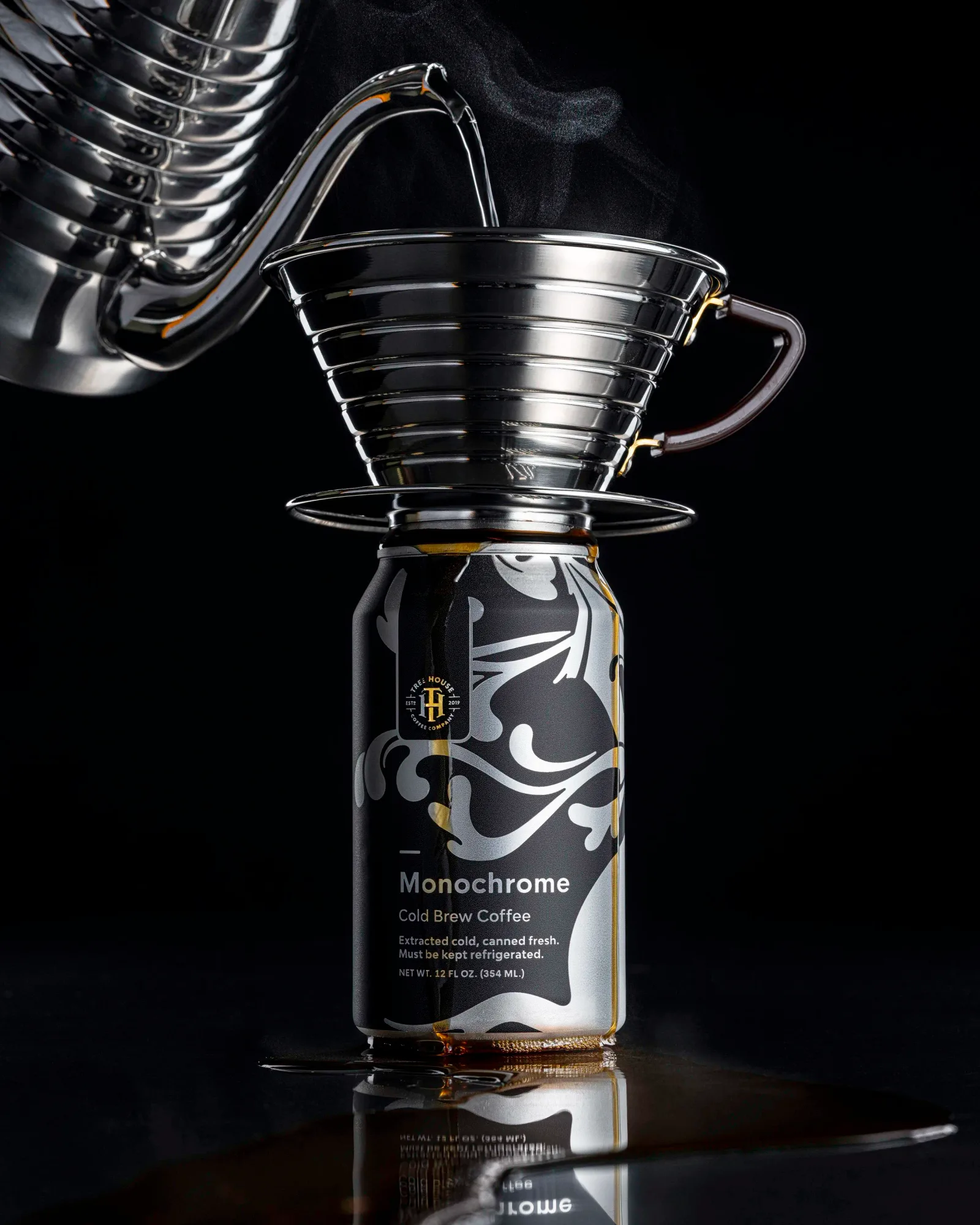 cold brew coffee can with pour-over dripper setup against black background., treehouse coffee company, charlton