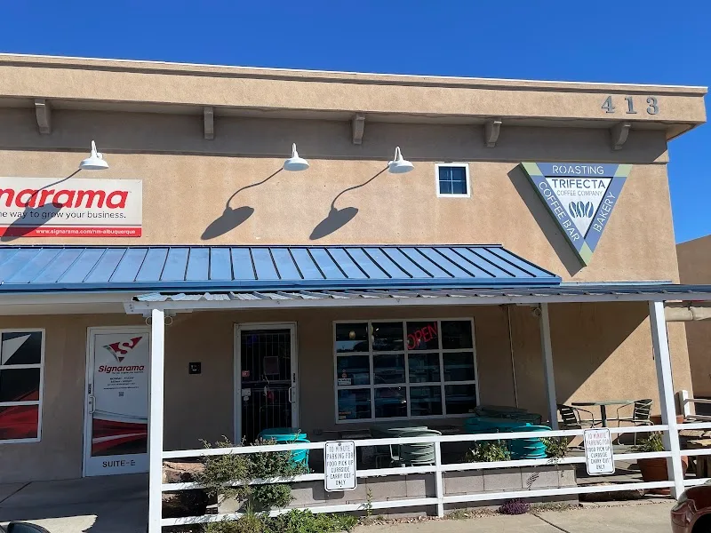 storefront with tan stucco building, metal roof, and coffee roastery signage at 418., trifecta coffee company, albuquerque