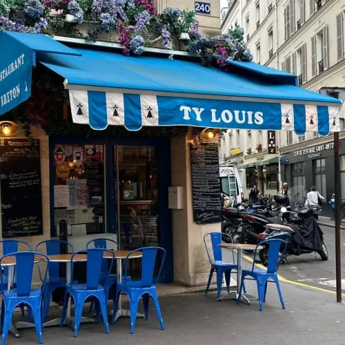 blue and white french bistro storefront with metal chairs on parisian street., ty louis - restaurant breton paris 12, paris