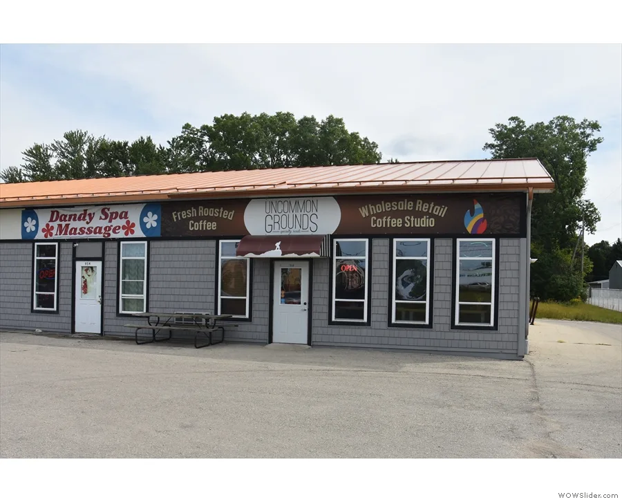 small commercial building with three businesses: spa, coffee roaster, and retail studio., uncommon grounds specialty roaster,