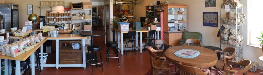 cozy café interior with wooden furniture, retail displays, and seating areas throughout., uncommon grounds specialty roaster,