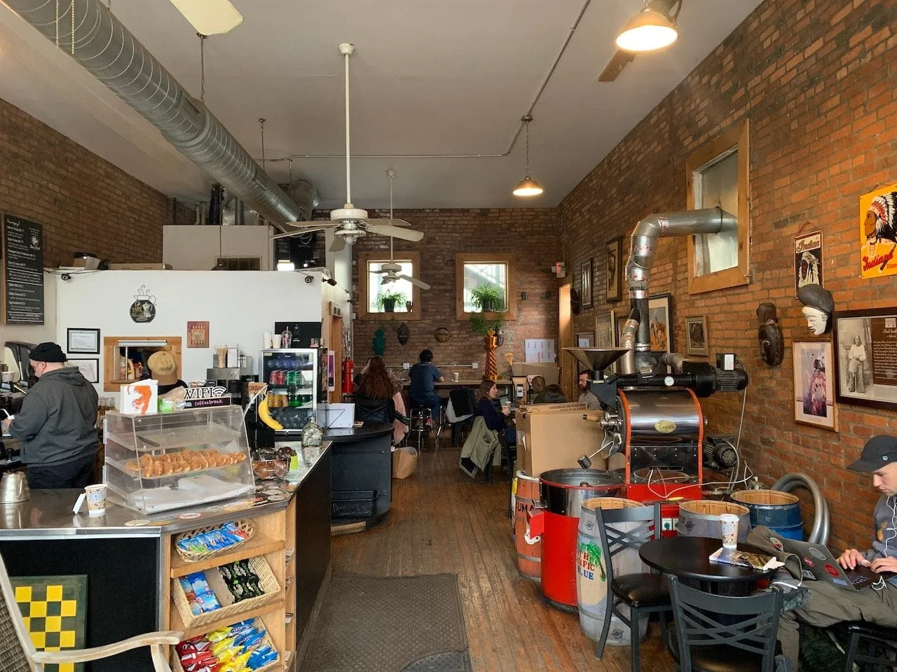 industrial brick café with roasting equipment, counter service, and vintage décor on walls., upper cup coffee, columbus