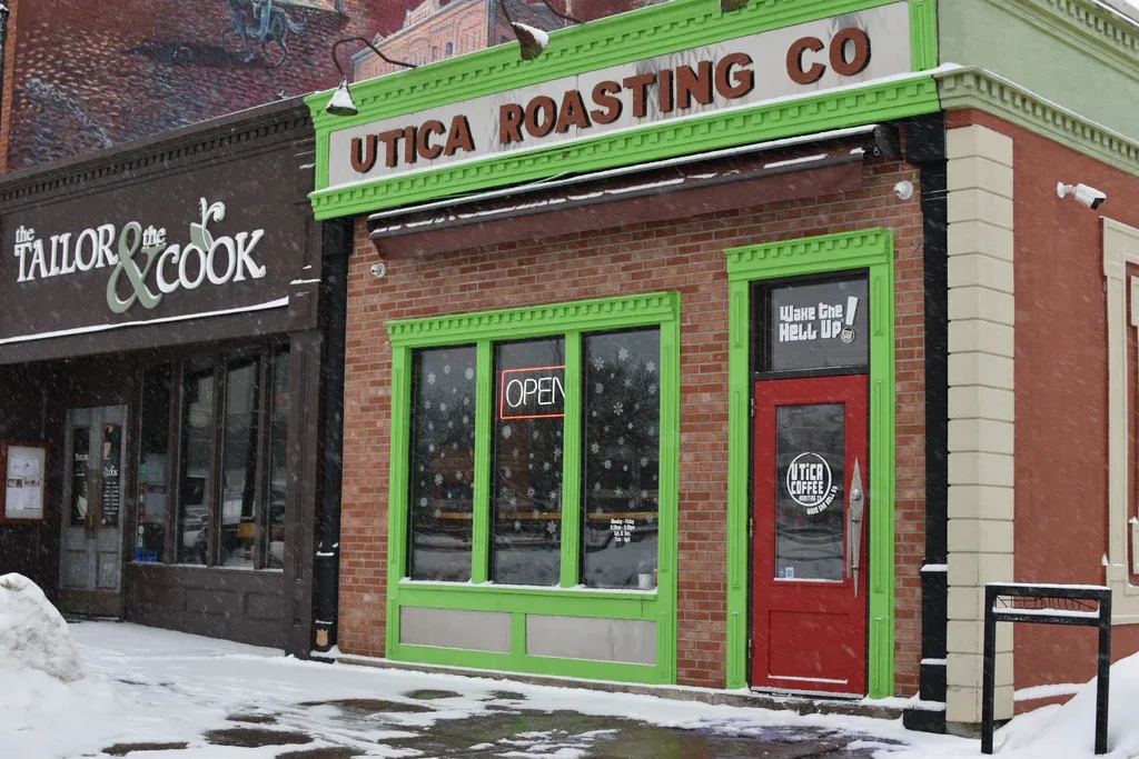 storefronts for utica roasting co and the tailor and cook on snowy street., utica coffee roasting co., utica