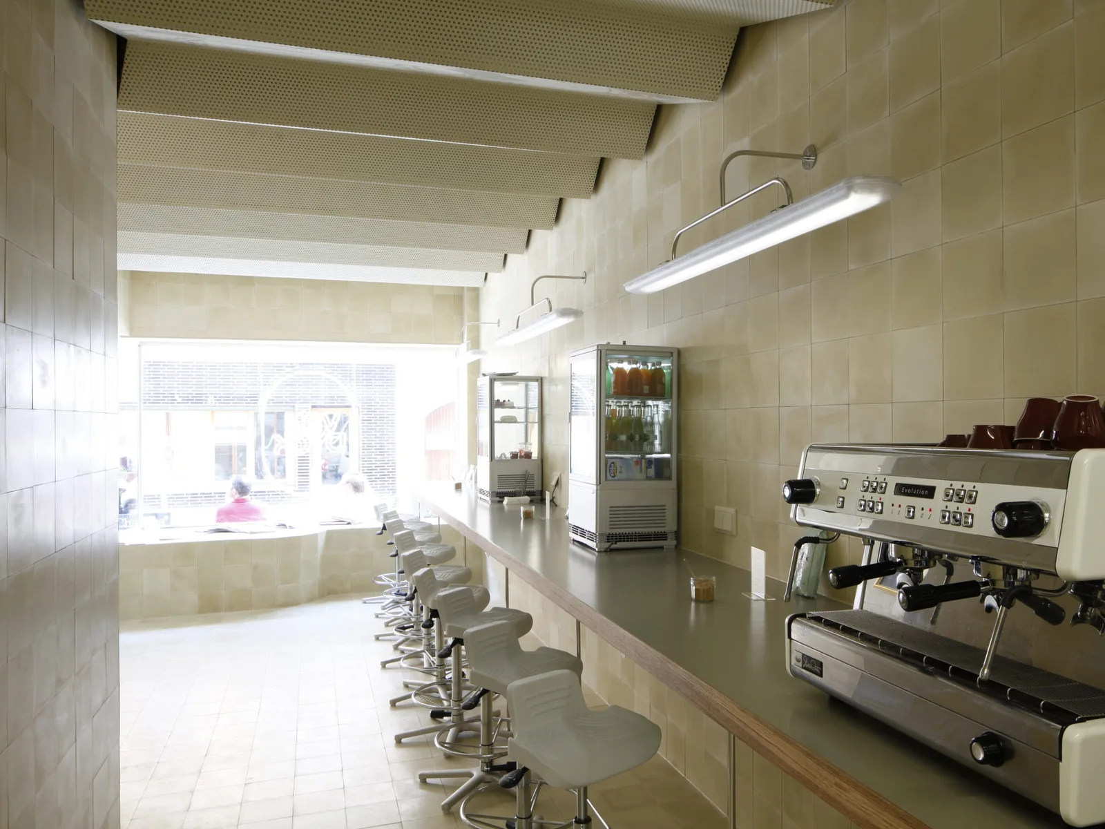 modern café interior with espresso machine, seating, and bright natural lighting from windows., van dyck, cologne