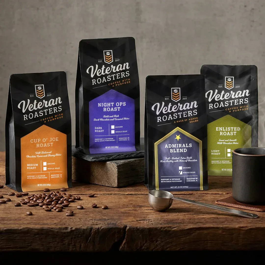 four veteran roasters coffee bags displayed on wooden table with beans and scoop., veteran coffee roasters, colorado springs