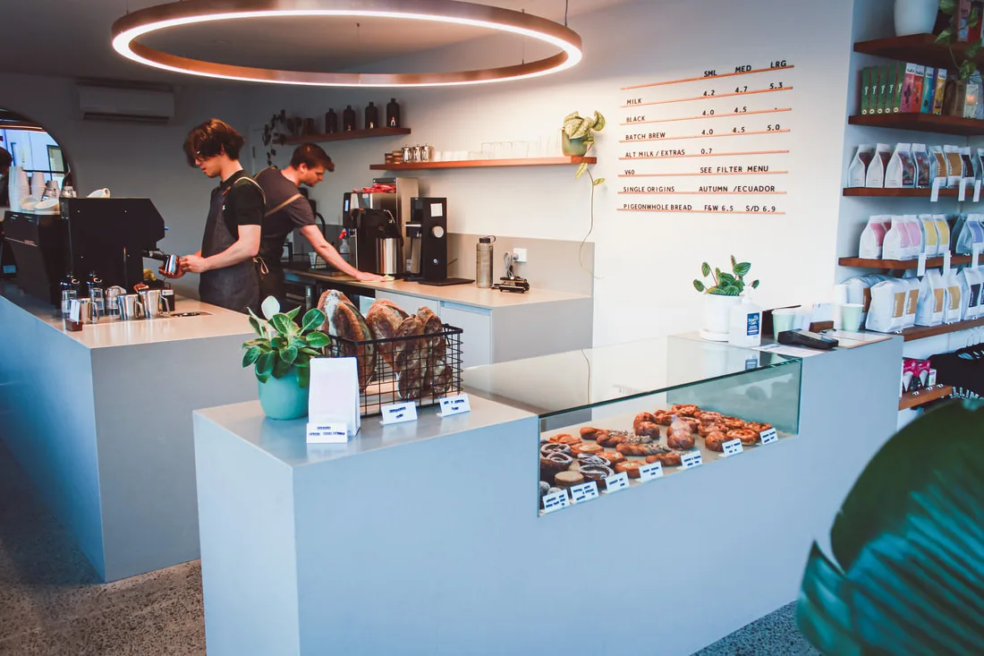 modern coffee shop interior with baristas, pastries, and specialty beverage menu displayed., villino coffee, hobart