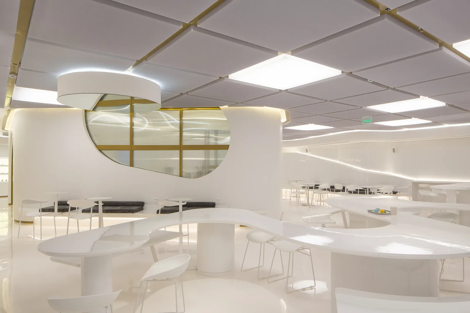 modern minimalist interior space with curved furniture, brass accents, and bright led lighting., we coffee morumbishopping, s