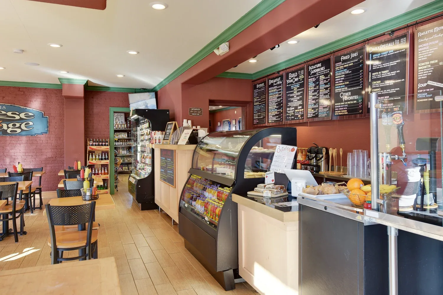 bakery café interior with pastry counter, menu boards, and dining area seating., west allis cheese & sausage shoppe, west all
