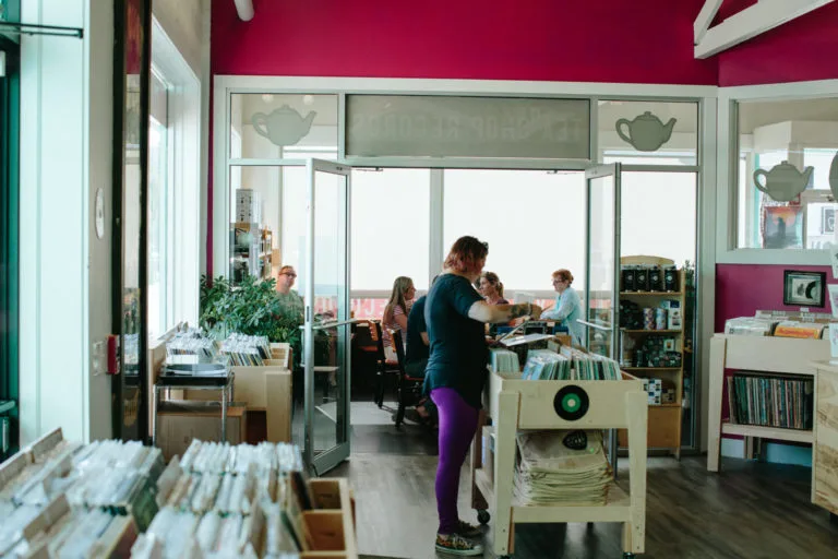 library or bookstore interior with visitors, burgundy walls, and glass partitions., white heron tea & coffee, portsmouth