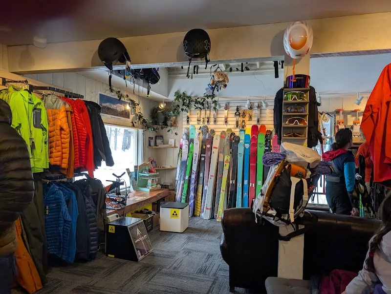outdoor sports retail shop displaying jackets, skis, snowboards, and climbing gear., white mountain ski co., jackson