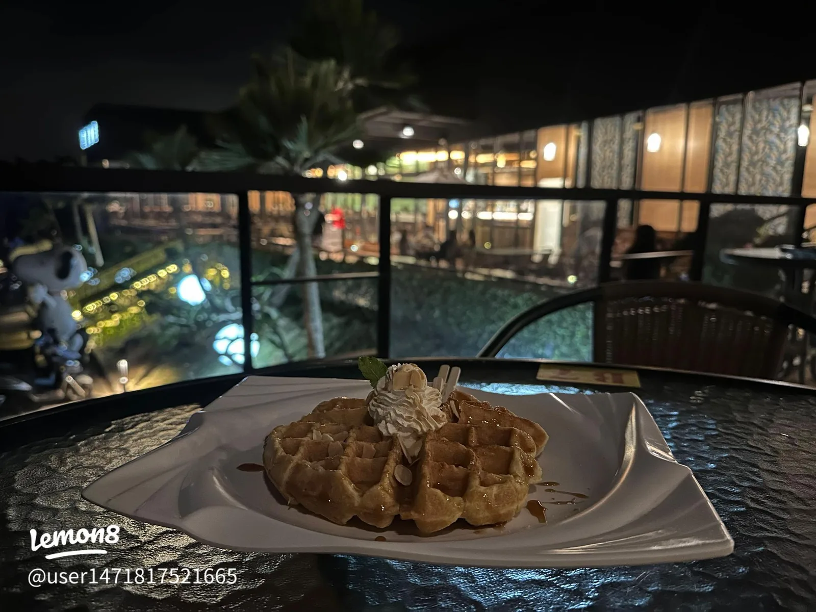 waffle with whipped cream and syrup on plate overlooking nighttime resort., wj-coffee, kaohsiung