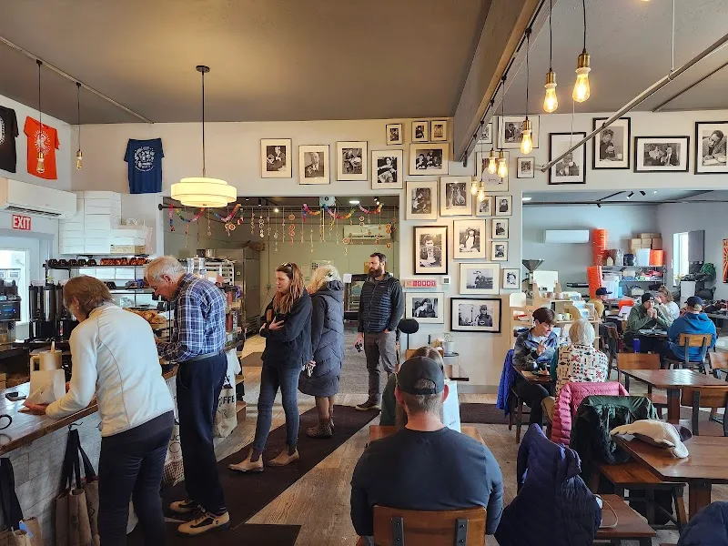 busy café interior with customers, vintage photo gallery walls, and counter service., wydaho roasters coffee house, driggs