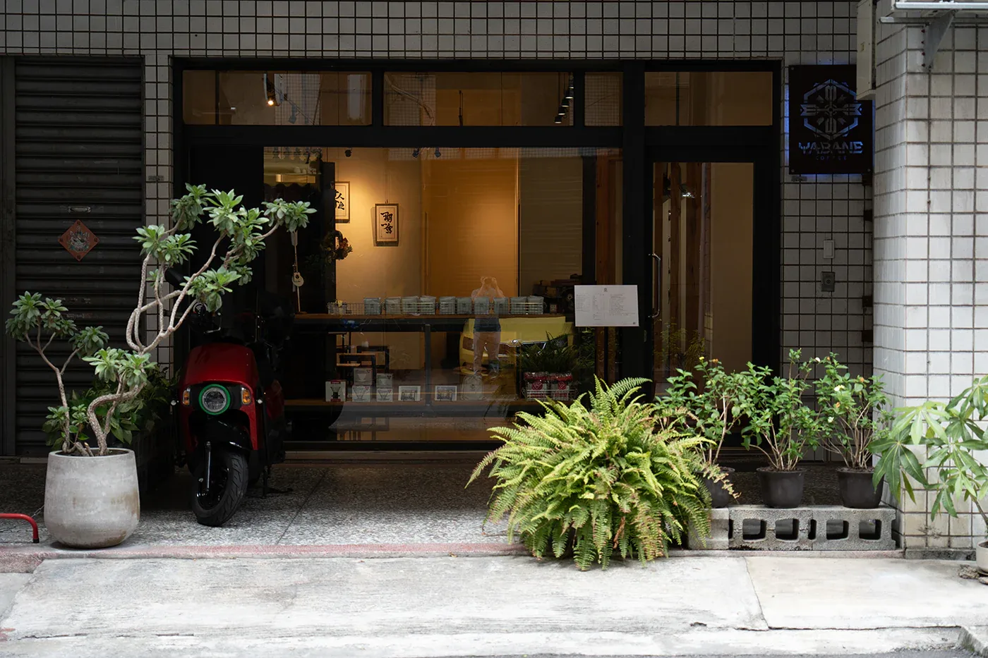 asian restaurant storefront with red scooter, plants, and warm interior lighting., yabane coffee, taichung